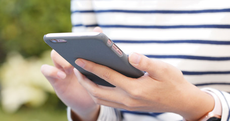 Use of smart phone over green park