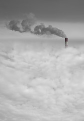 Big power station chimney with smoke above the city smog