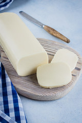 White mozzarella on blue concrete stone background table. Healthy Food Concept. Daily product. Copy space © Anikonaann
