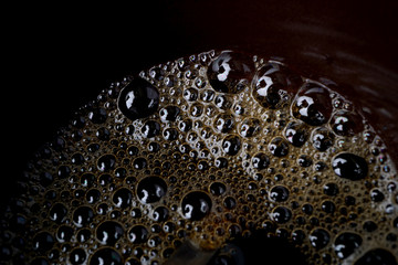 Macro, close up of small bubbles in coffee cup