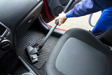 Handyman's Hand Vacuuming Car Mat