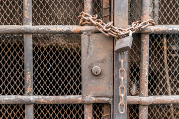 Closed bars with old chain and lock