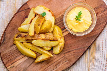 fried potato wedges with cheese sauce