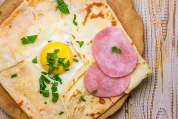 Pancake with egg and ham top view