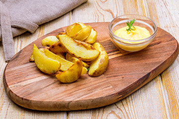 fried potato wedges with cheese sauce