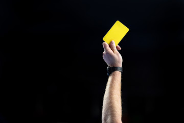 referee hand with yellow card - obrazy, fototapety, plakaty