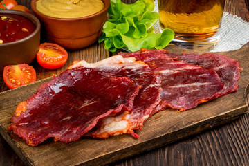 Smoked meat cut into pieces on the background