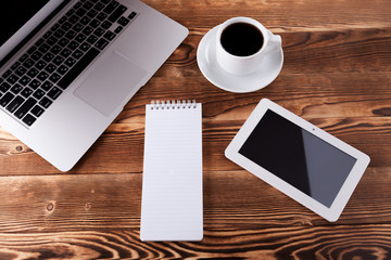 Top view of studying process with copybook, book and laptop. Cups of coffee on the table
