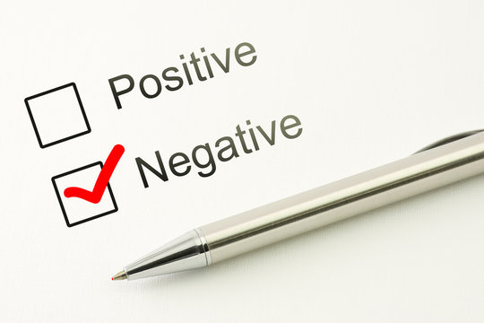 questionnaire: negative choice or positive, marked checkbox with a pen on paper background. Disapproval concept