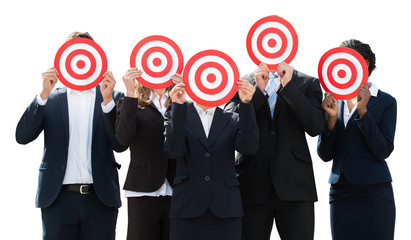 Businesspeople Hiding Face With Dartboard