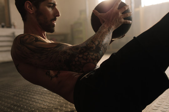 Man doing exercise with medicine ball