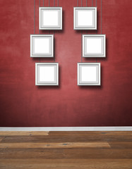 Red textured wall and Alu frames hanging