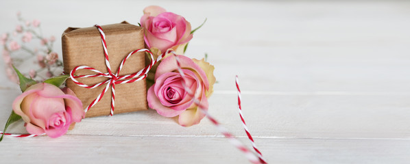 Tender pink roses with a gift