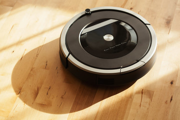 robotic vacuum cleaner on laminate wood floor smart cleaning technology