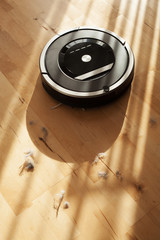 robotic vacuum cleaner on laminate wood floor smart cleaning technology dust
