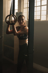 Woman working out on gymnast rings