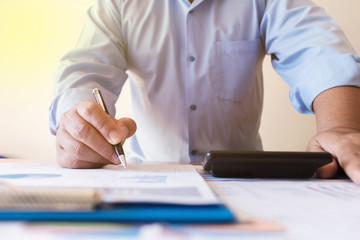 Human hand suing pen supplies working for business.