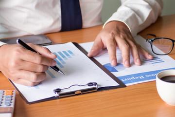 Human hand suing pen supplies working for business.