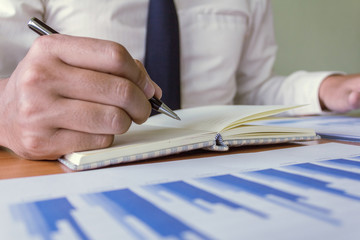 Human hand suing pen supplies working for business.