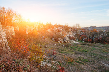 Fototapeta premium View on the beautiful colorful autumn landscape of the hills with trees, rocks and greenfields in the countryside