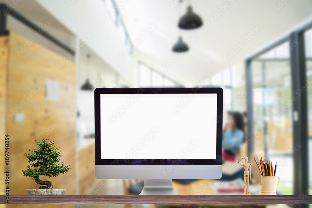 Poster work place concept : mock up blank screen computer desktop in cafe or co-working background.