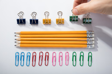 Person Arranging The Pencils On White Background