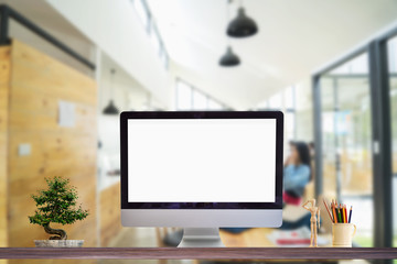 Fototapeta premium Work place concept : Mock up Blank screen computer desktop in cafe or co-working background.
