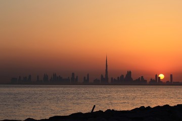 DUBAI SKYLINE UNDER SUNRISE, TWO LANDMARKS, BURJ AL ARAB AND BURJ KHALIFA, THE TALLEST BUILDING IN THE WORLD