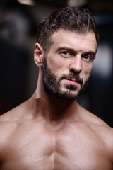 Fototapeta premium sexy strong bodybuilder athletic men pumping up muscles with dumbbells