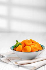 Delicious dried apricots in a plate on the table. Copy Space. The concept is healthy food, diet, vegetarianism.