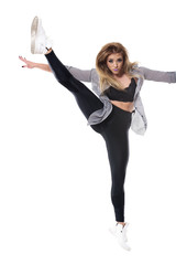 Energetic woman dance hall dancer jumping with raised leg in mid air position. Full body length portrait isolated on white studio background. 