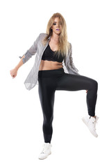 Fototapeta premium Passionate energetic sexy dance hall female dancer looking down with tousled hair. Full body length portrait isolated on white studio background. 