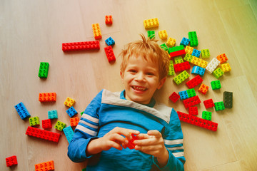 child play with colorful plastic blocks indoor