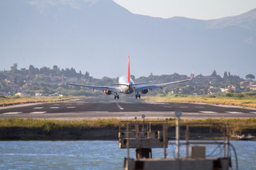Fototapeta premium Airplane landing on Corfu airport