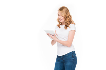 portrait of smiling woman using digital tablet isolated on white