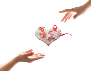 World aids day with red ribbon awareness on heart globe and woman hands. Element of this image furnished by NASA