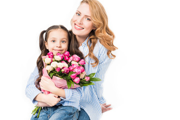 cheerful mother and little daughter with bouquet of flowers isolated on white, mothers day concept