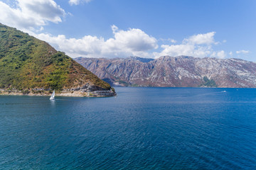 Fototapeta na wymiar Aerial view on a white yacht under a white sail. Montenegro.