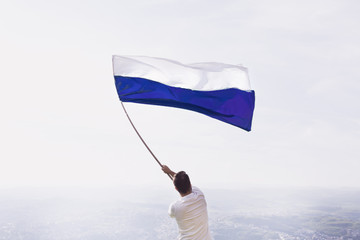 Men with a blue and white flag
