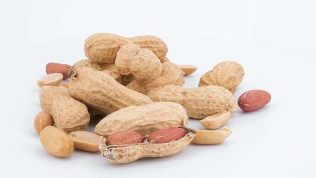 Peeled and whole peanuts rotation isolated on white (loopable)