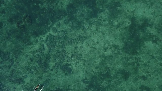 Birds eye view of fisherman on pirogue boat on sea
