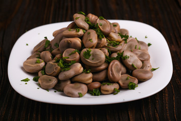 boiled broad beans on a rustic background
