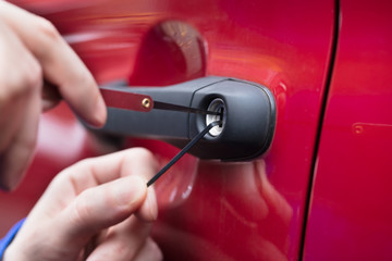 Human Hand Opening Car's Door With Lockpicker