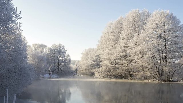 Winter river landscape. Beautiful dawn in the winter park, time-lapse 4K.
