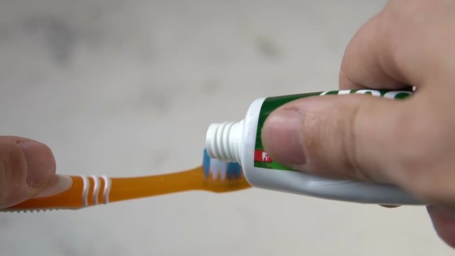 Toothbrush and toothpaste on blurred background