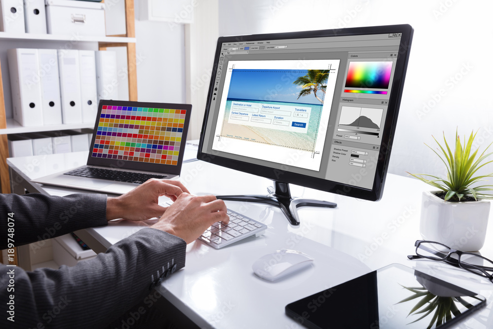 Poster designer editing photo on computer