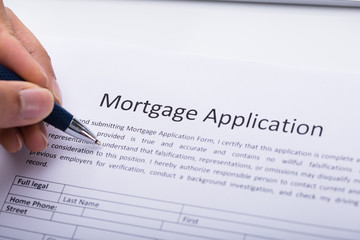 Person Filling Mortgage Application Form