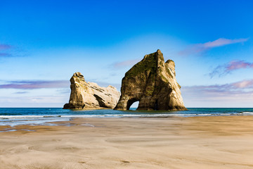 New Zealand wharariki beach and arch island rock formations - 189749834