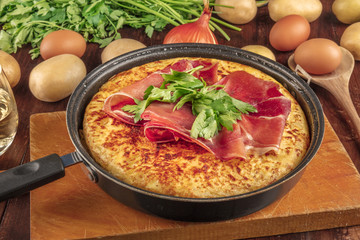 A closeup photo of a Spanish tortilla with ingredients