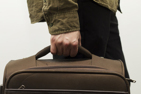 Close up on suitcase in man's hand